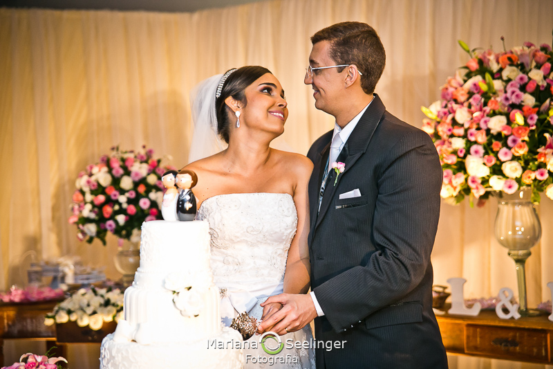 sorrindo e cortando o bolo