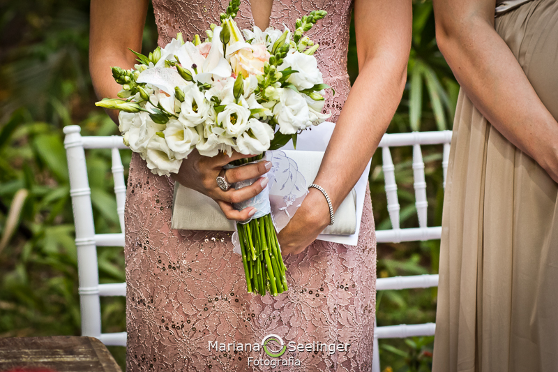 Foto da mãe da noiva segurando o bouquet da noiva em casamento registrado por Mariana Seelinger Fotografia de Casamentos e Familias em Niterói RJ