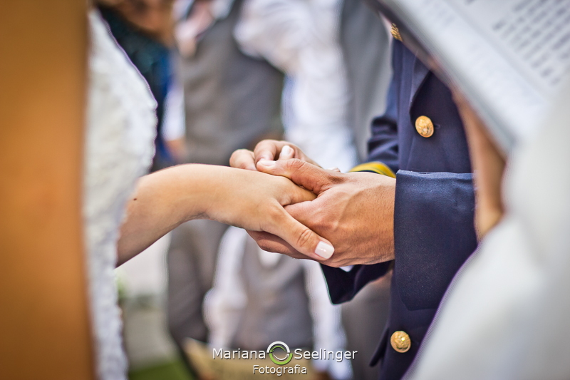 Foto romântica dos noivos trocando as alianças no altar em fotografia de Mariana Seelinger Fotógrafa de Casamentos em Niterói e RJ