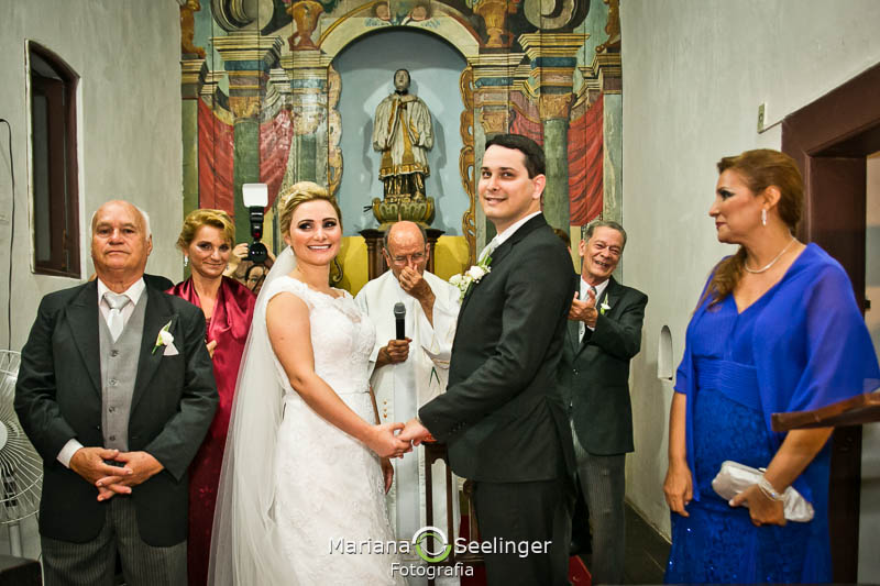 Noivos de mãos dadas no altarem casamento registrado por Mariana Seelinger Fotografia de Casamentos e Familias em Niterói RJ