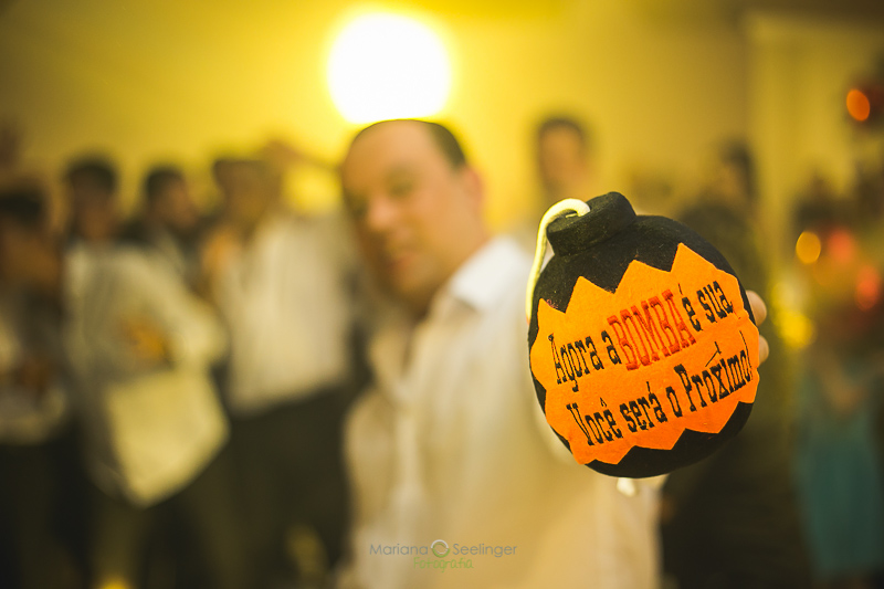 Noivo tacando bomba para os convidados em casamento registrado por Mariana Seelinger Fotografia de Casamentos e Familias em Niterói RJ