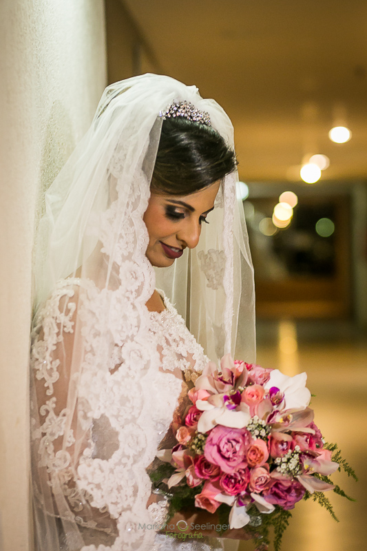 Noiva em making of com bouquet com flores rosas e brancas em casamento registrado por Mariana Seelinger Fotografia de Casamentos e Familias em Niterói RJ
