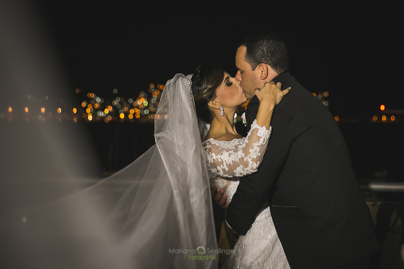 Foto do beijo dos noivos na sacada da casa de festa em casamento registrado por Mariana Seelinger Fotografia de Casamentos e Familias em Niterói RJ
