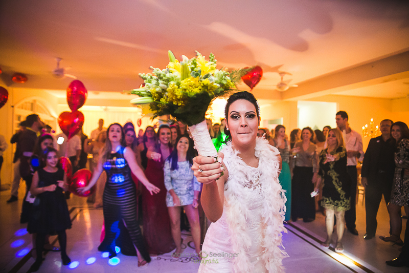 Momento da jogada do bouquet em casamento registrado por Mariana Seelinger Fotografia de Casamentos e Familias em Niterói RJ
