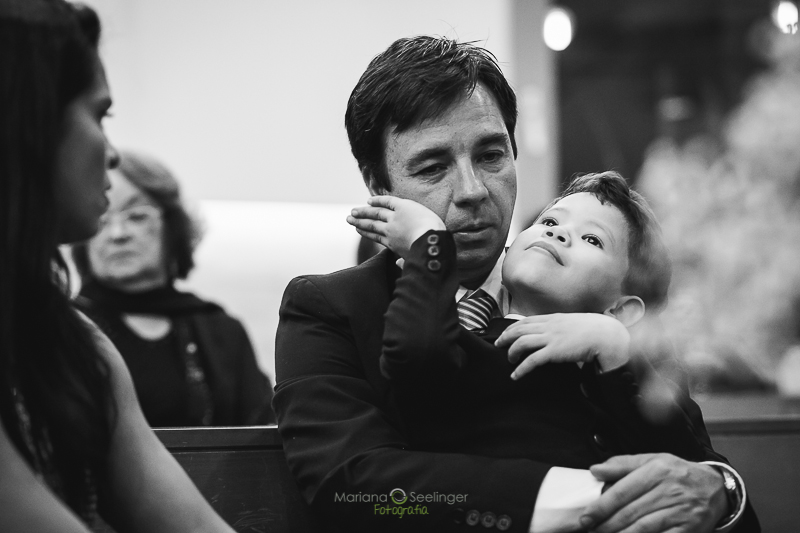 Padrinho do casamento com filho no colo em casamento registrado por Mariana Seelinger Fotografia de Casamentos e Familias em Niterói RJ