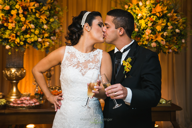 Foto do casal com copo se beijando em casamento registrado por Mariana Seelinger Fotografia de Casamentos e Familias em Niterói RJ