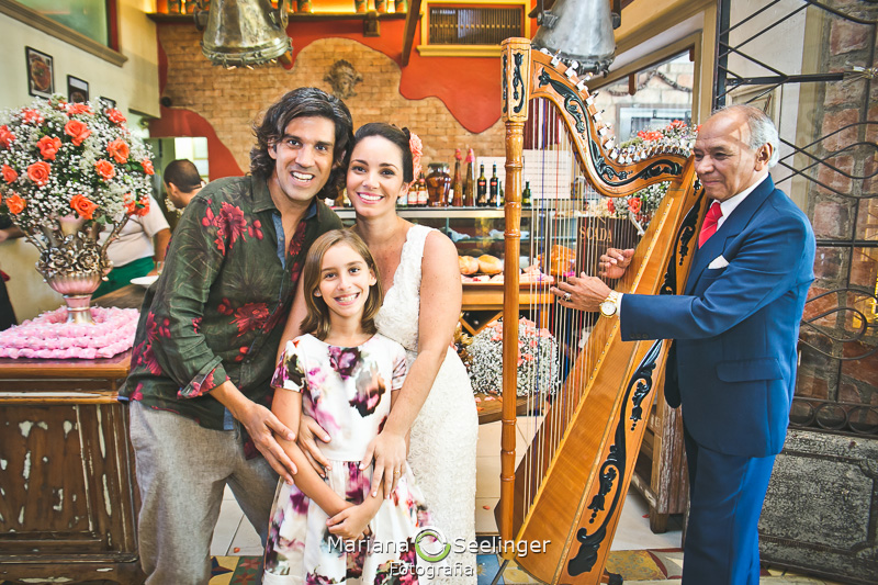 Casal de noivos e a filha procimos a decoração italiana no restaurante da carmine em fotografia de Mariana Seelinger Fotógrafa de Casamentos em Niterói e RJ