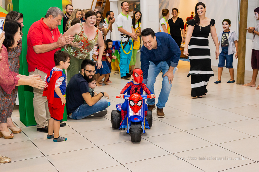 Fotografia do aniversariante brindo, sua festa com decoração da liga da justiça e vingadores no Jungle Frends em Maringá.