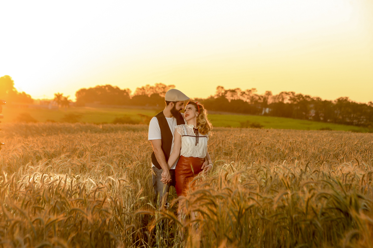 casal junto no ensaio de pre-wedding em uma plantação de trigo feita no por do sol em Holambra cidade das flores 