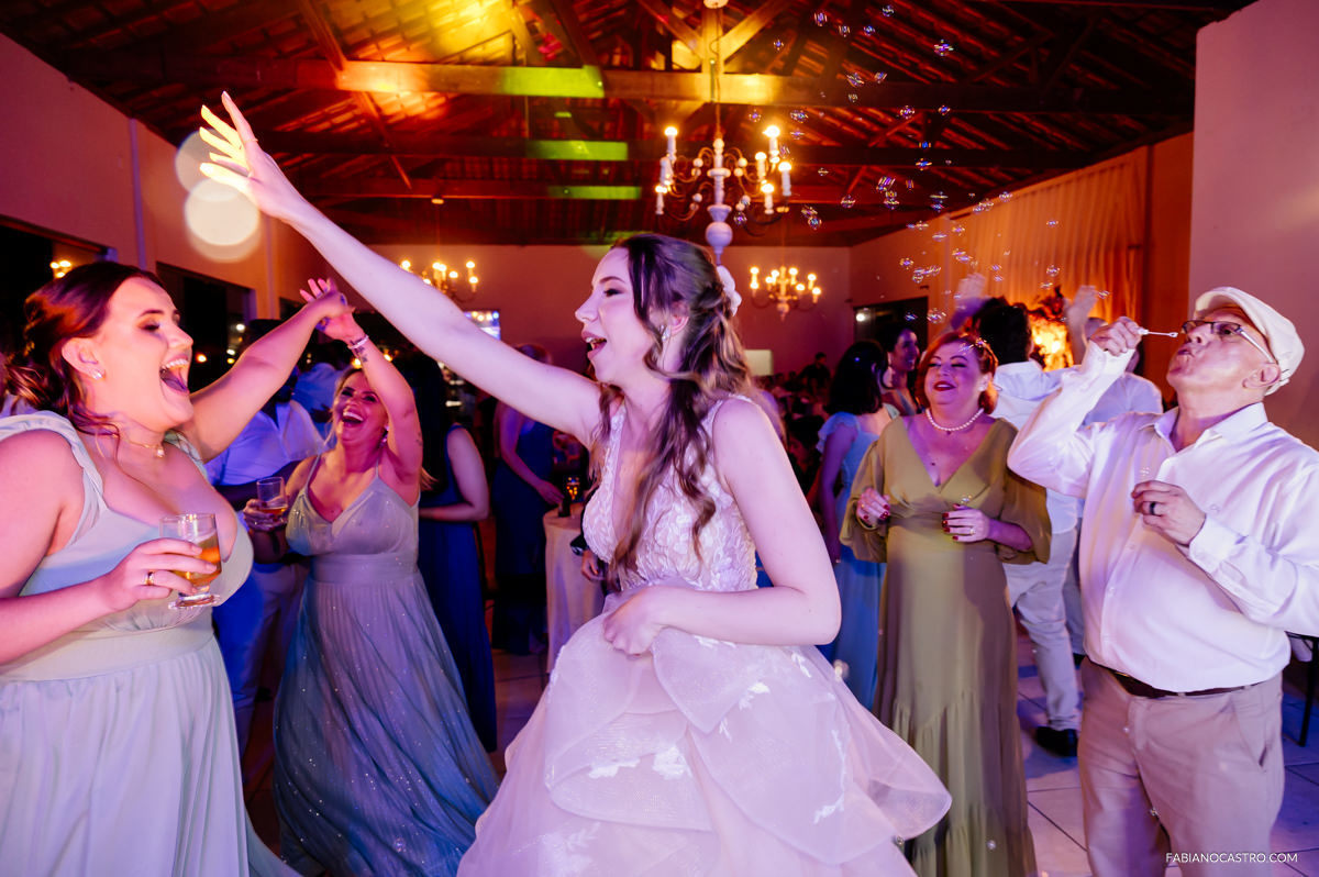Noiva Luiza se divertindo com convidados durante festa de seu casamento no Rancho Fundo em Alfenas-MG