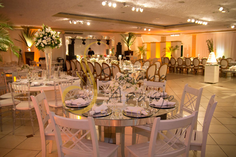 Decoração de casamento Solar Imperial, mesa de convidados de espelho com flores e arranjos de flores brancas. Composta com sousplat, guardanapos e taças