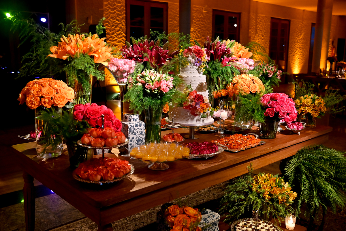 Aniversário de 40 anos - Rio Cricket - Mesa de bolo e doces com flores em tons de laranja, rosa e marsala.