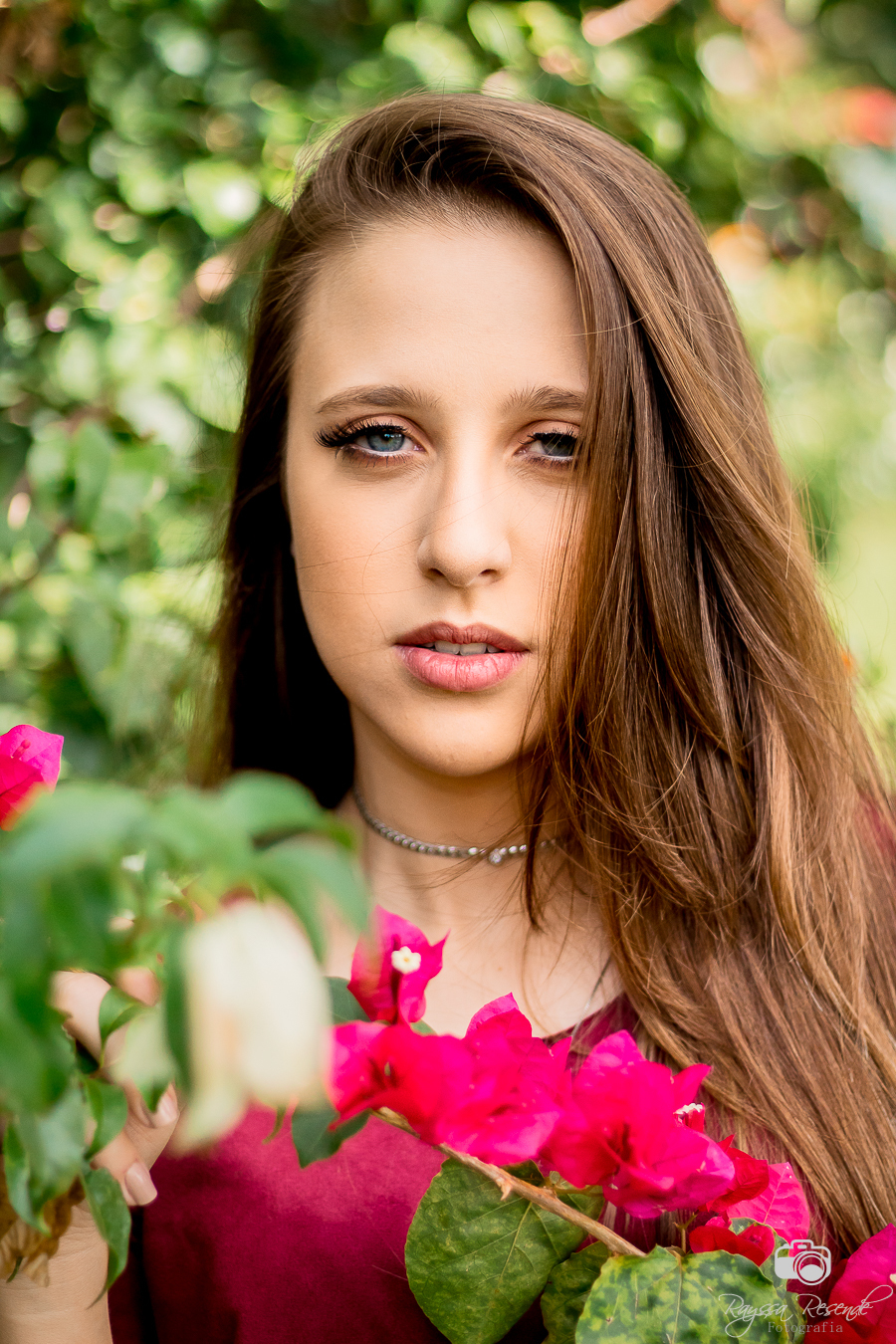 menina de olhos azuis modelo para ensaio fotográfico externo com flores rosas