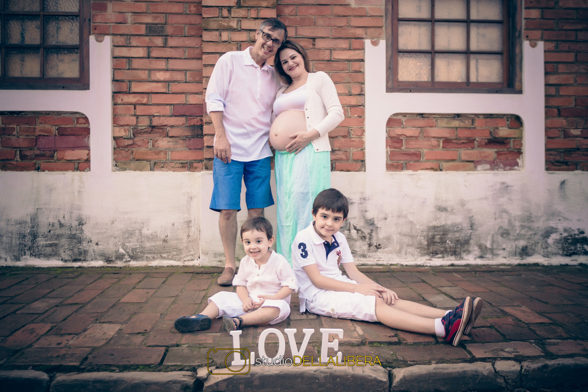 toda a família para foto da gestação de esperada Bebê com palavra love na frente