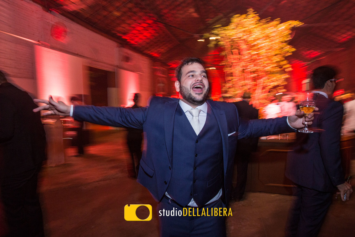 Foto feita pelo fotografo de casamento Wilson Della Libera Junioir do noivo com os braços abertos dançando em movimento, divertindo muito na festa de seu casamento
