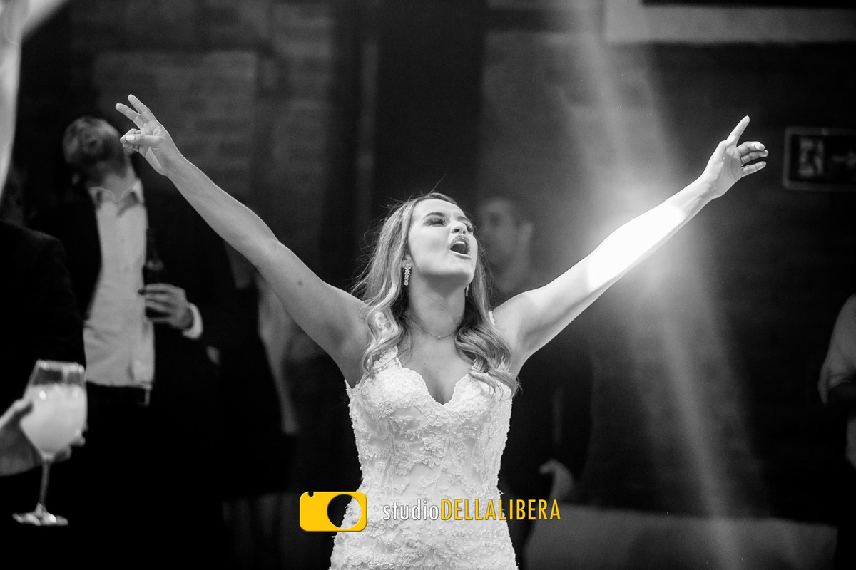 Noiva Ana Maria dançando com os braços abertos sorriso no rosto durante a festa de casamento no espaço Zara em Piracicaba SP