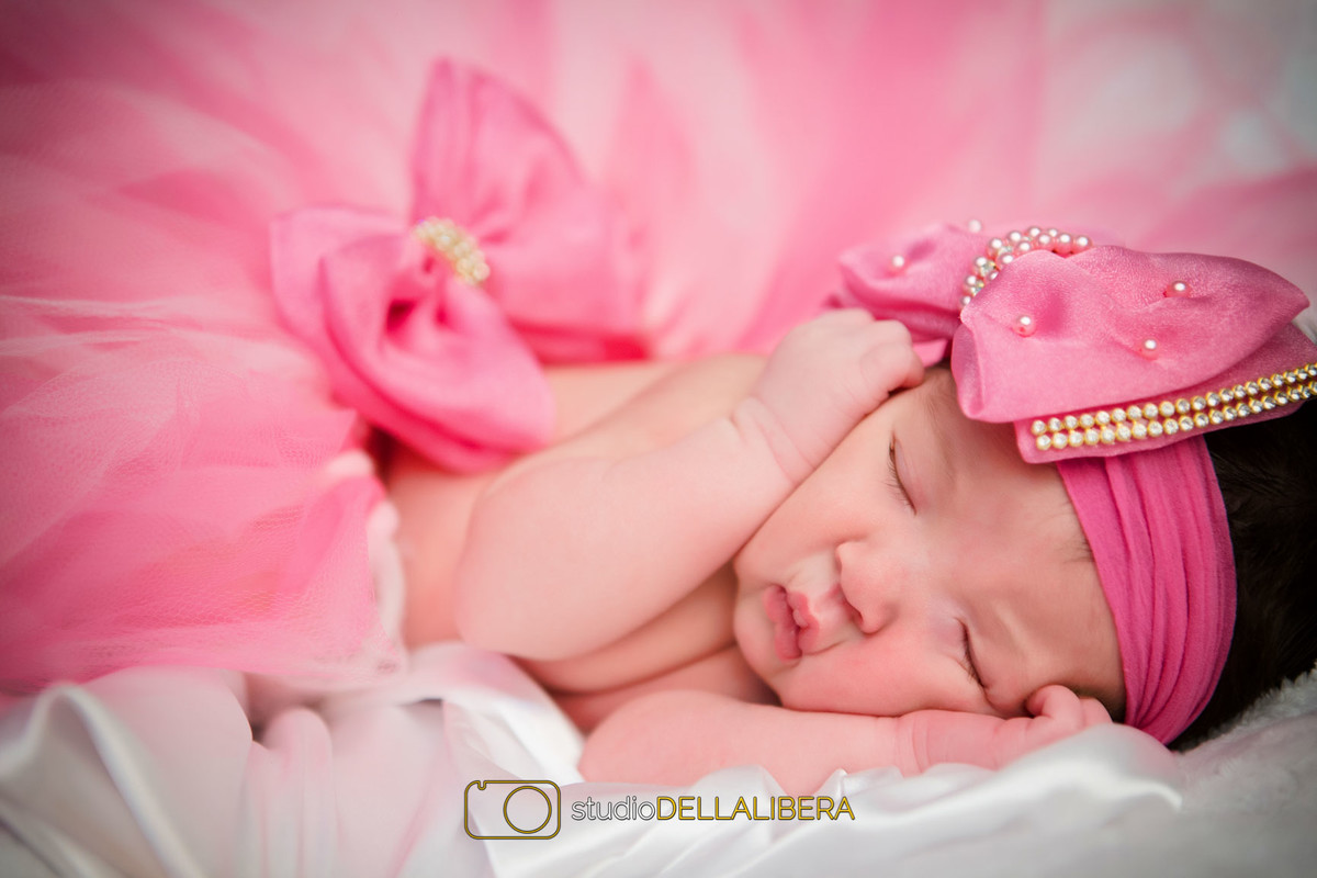 sessão de newborn com saia e detalhe de cabelo na cor pink