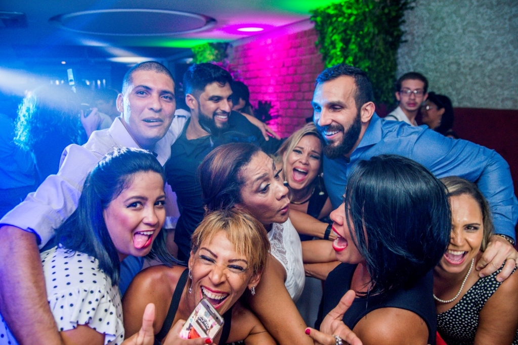 Nossa Casa Estúdio Gilson Freitas Fotógrafo profissional de casamentos fotografia de matrimônio em Niterói Rio de Janeiro com vestido branco e noivo casal na pista de dança e convidados dançando DJ Iluminação espaço Dimattoni felizes Noiva 