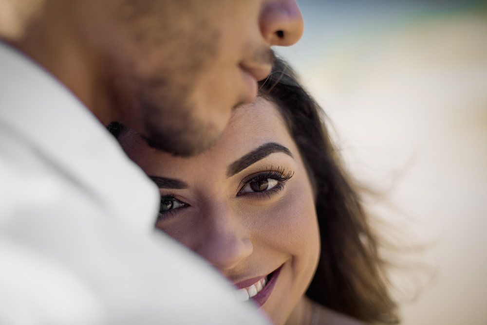 Melhor fotógrafo Nossa Casa Estúdio ensaio fotográfico profissional de casal na cidade de Niterói Rio de janeiro para pré wedding e casamento na praia de adão e eva ao por do sol na areia e mar com noivos/namorados vestidos de branco. Maquiagem noiva