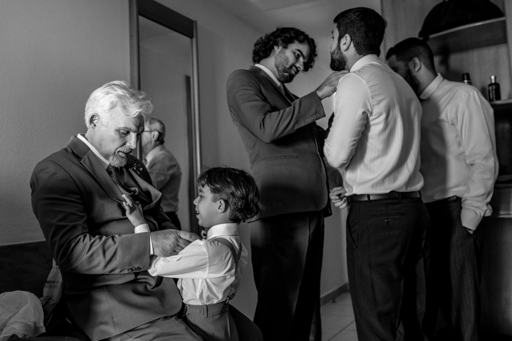 Hotel Atlântico Búzios Nossa Casa Estúdio fotografia de casamento em Niterói Rio de Janeiro Búzios Cabo Frio making of do noivo colocando terno e gravata com sapatos sociais para casamentos com fotógrafo profissional Gilson Freitas cobrindo o evento