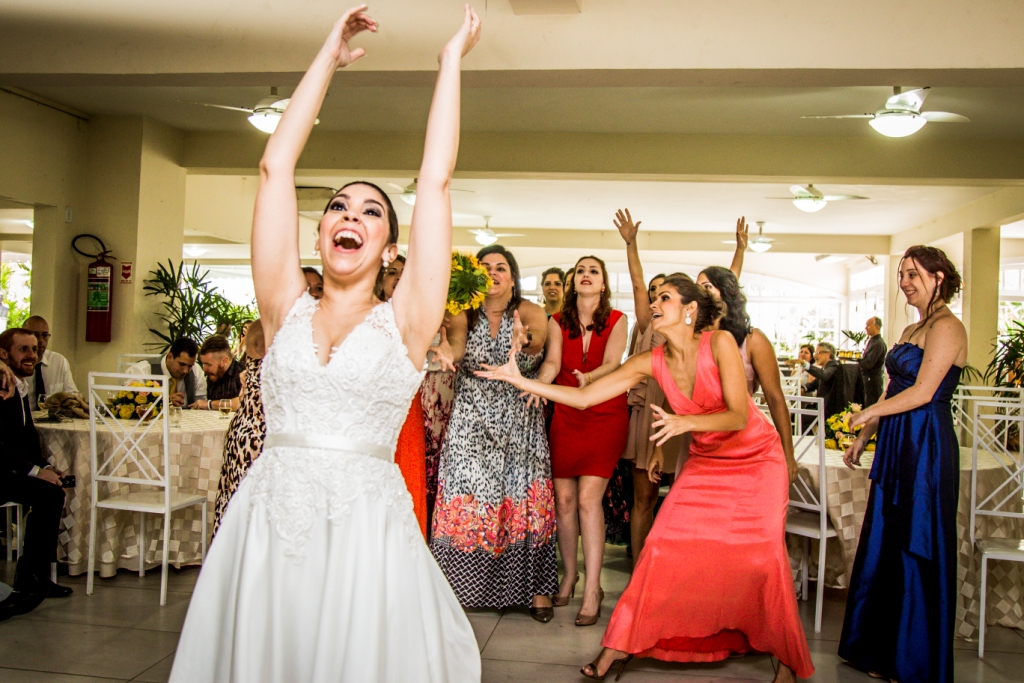 Momento do buquê, noiva jogando o buquê, irmã da noiva de vestido salmão pegou o buquê em festa de casamento, na cidade de Niterói, Rio de Janeiro, Noiva Feliz
