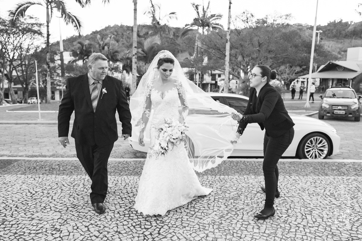 cerimonialista arrumando o véu da noiva