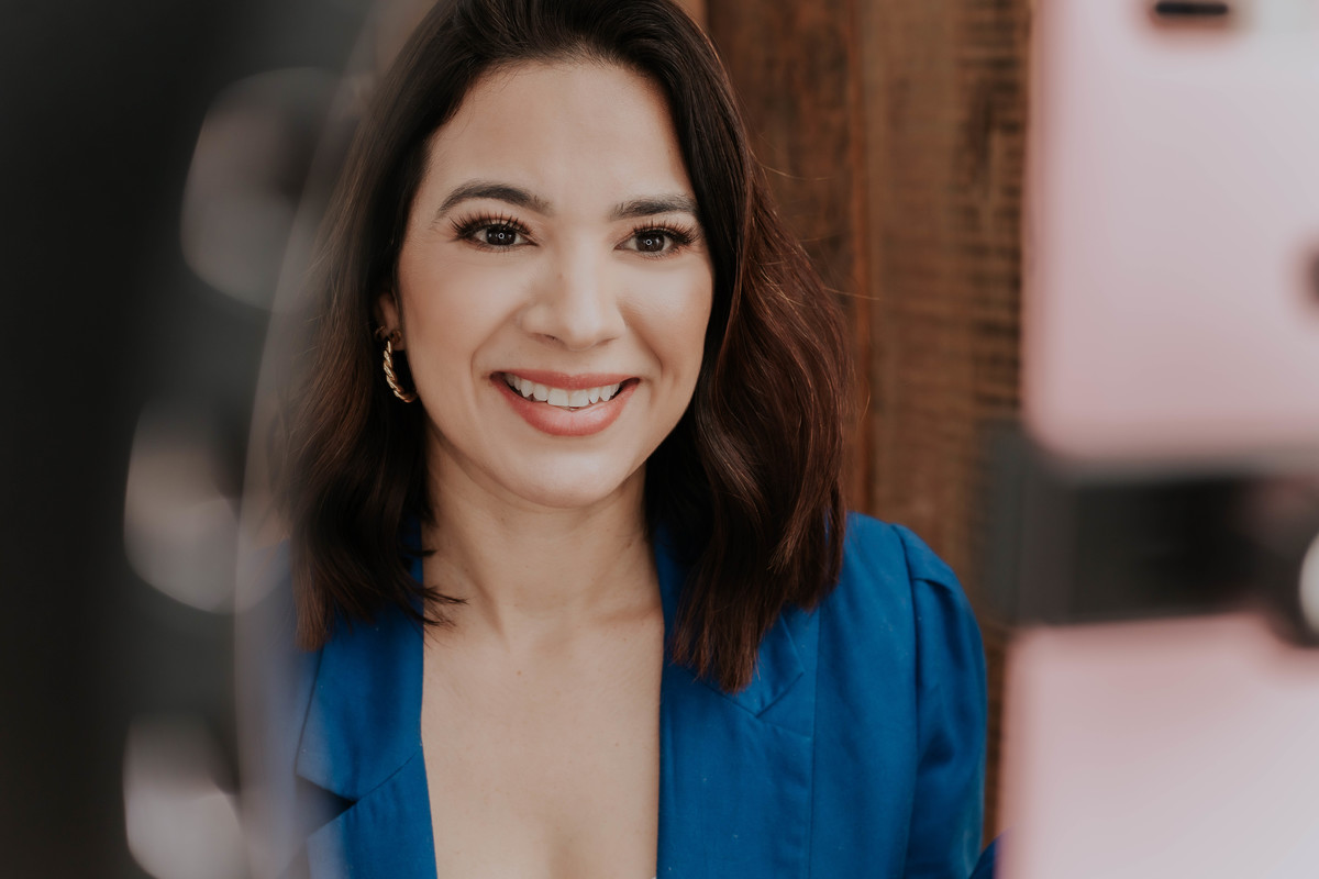 mulher blaser azul Coach em frente a ring light foto pertinho