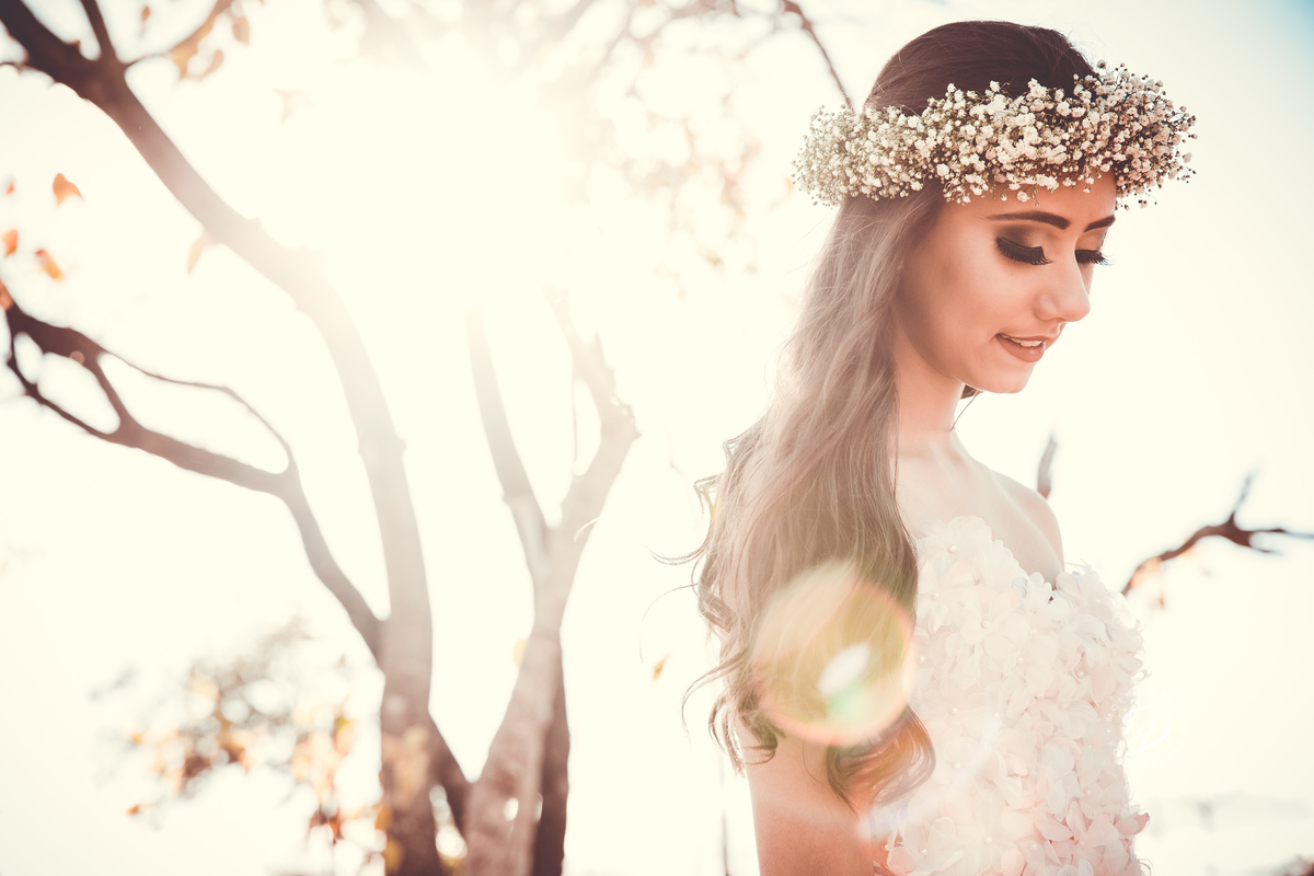 Debutante 15 anos natureza ar livre coroa de flores vestido rosa floral galhos luz natural