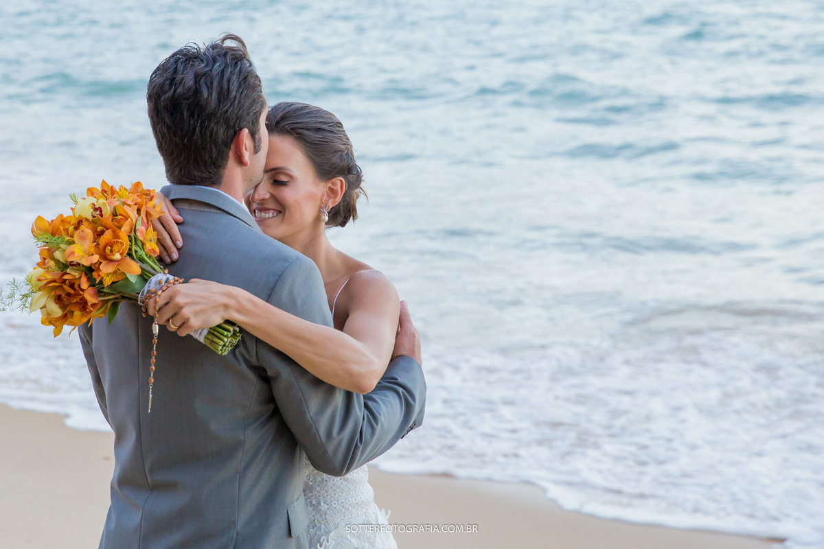 NOIVOS ABRAÇADOS APÓS A CERIMONIA NA PRAIA , MOMENTO DE MUITO AMOR 