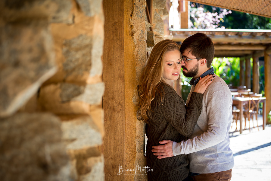 casal encostado na parede de pedra