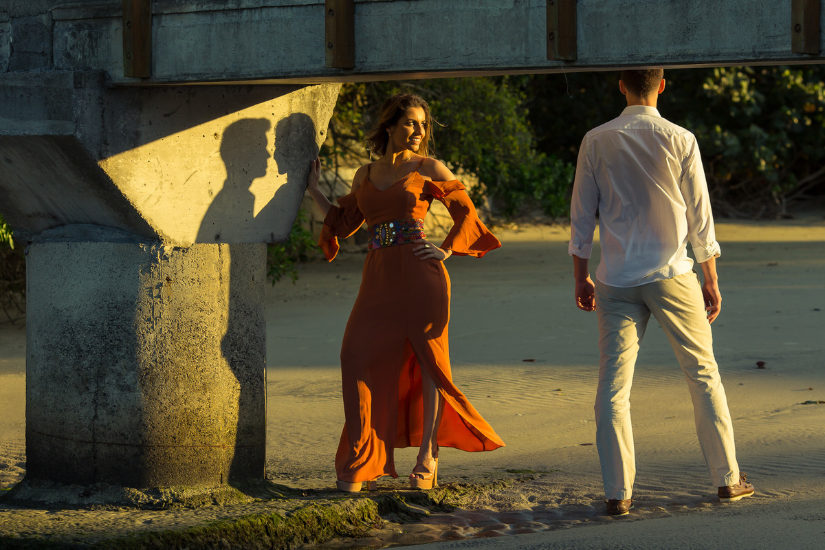 noivos sob o sol de fim de tarde na praia da armação em florianópolis