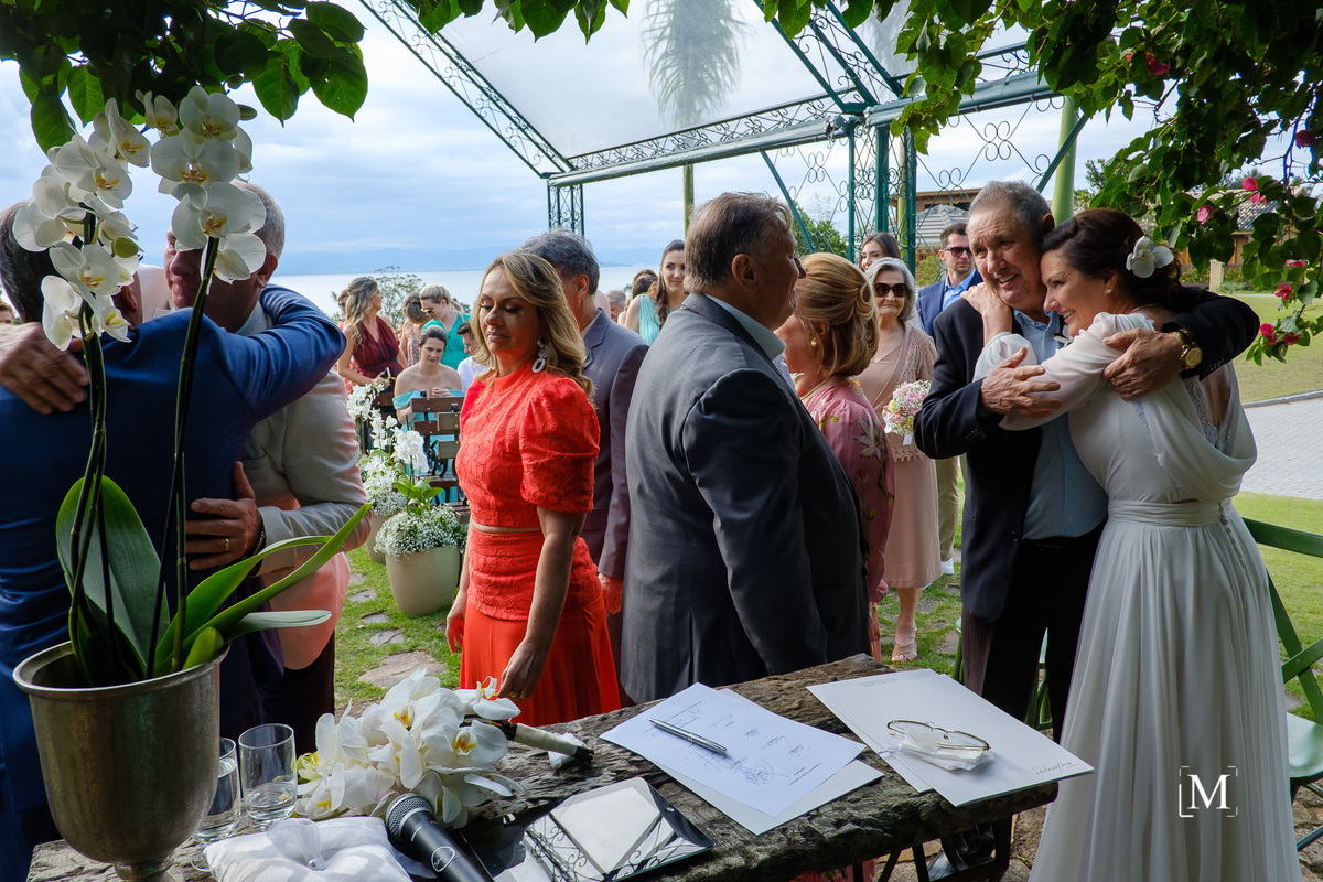 abraços dos noivos em seus pais no altar