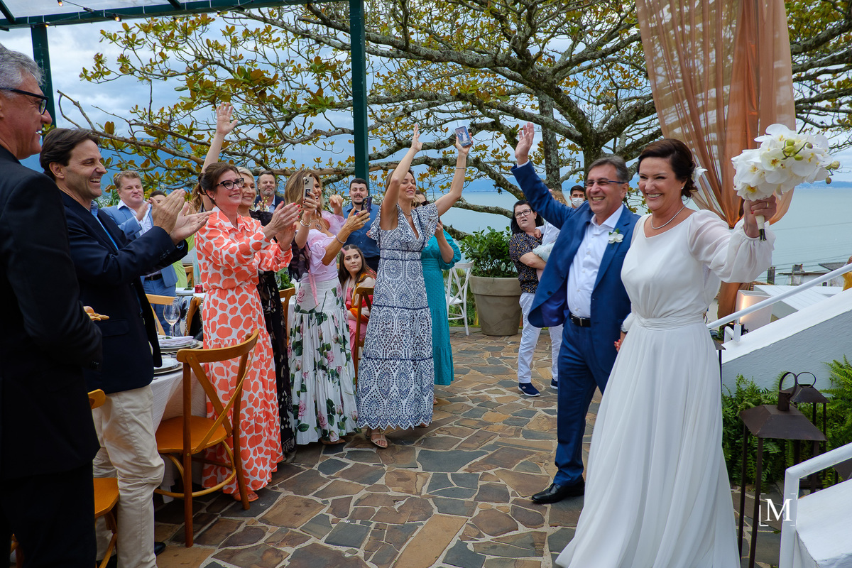 noivos entrando na festa e convidados aplaudindo