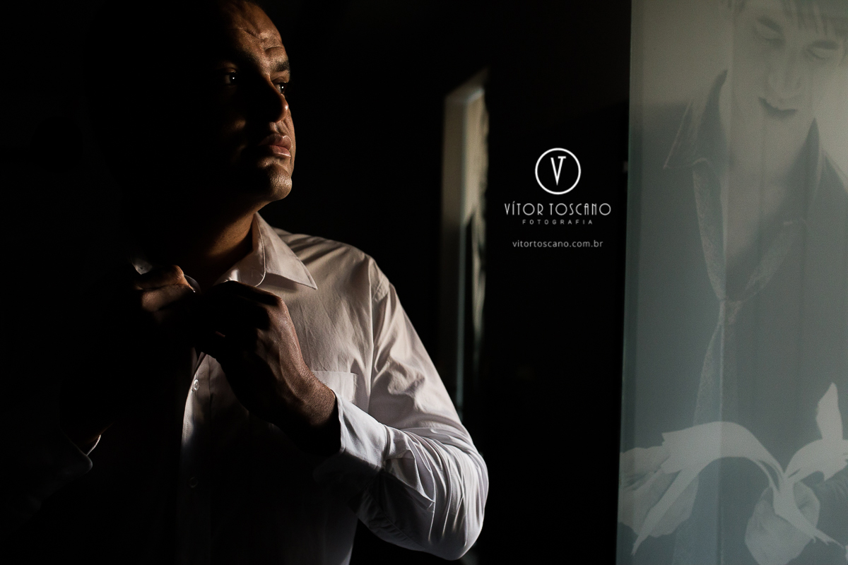 Noivo arrumando a gravata no making off do casamento de Jucielly e Auderi, em Natal-RN.