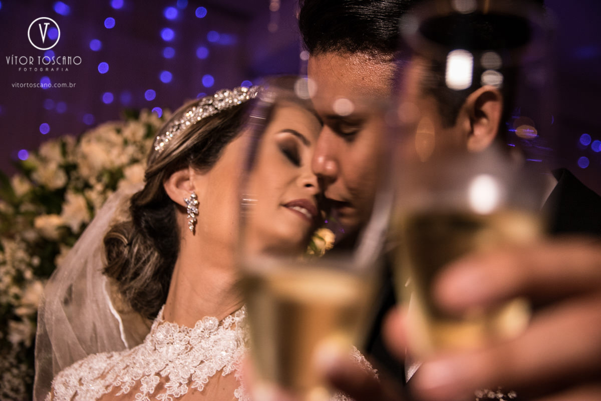 Casal se beijando por trás do copo no casamento de Tanísia e Felipe, em Natal-RN.