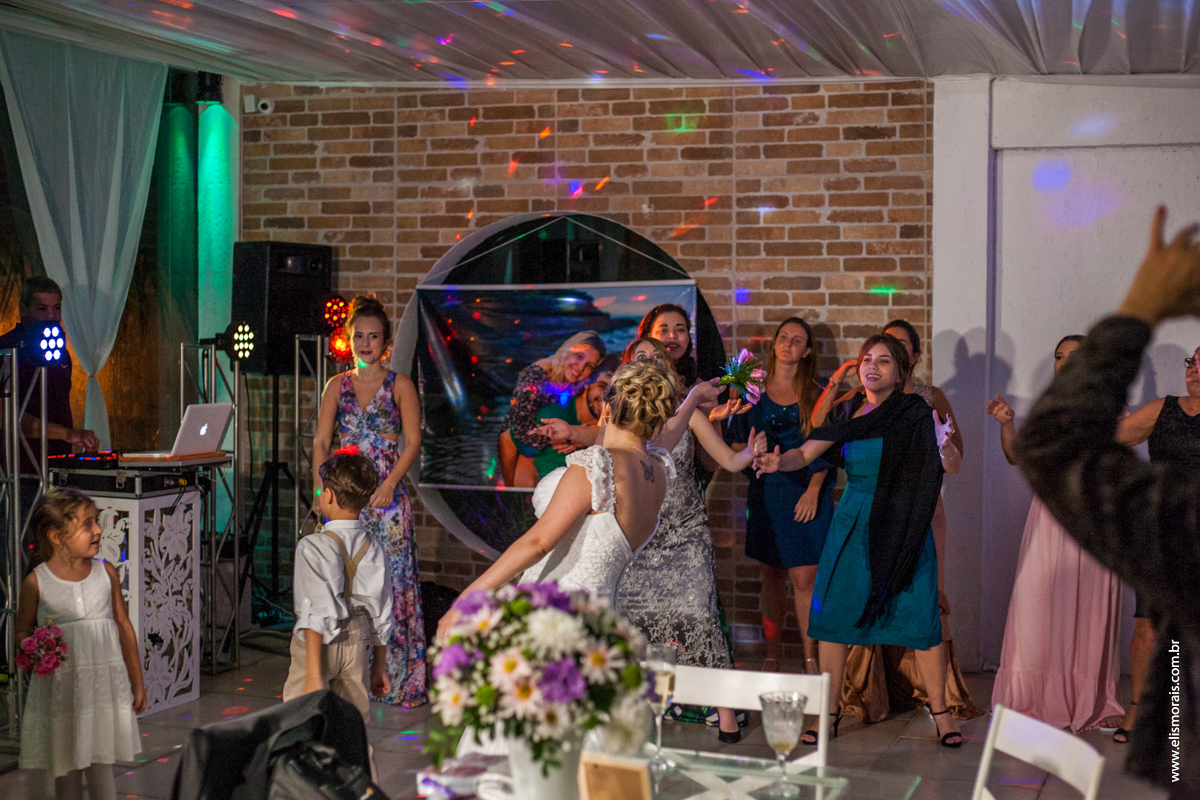 fotografia da noiva jogando o bouquet na festa de casamento na Mansão das Orquídeas Casa de Festas em Araruama - RJ