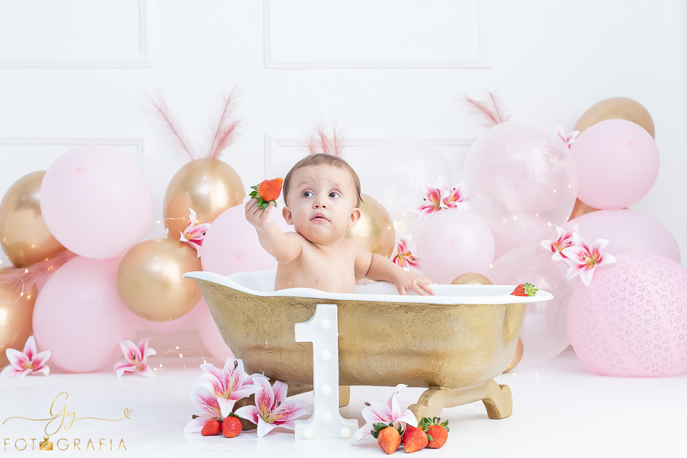 Ensaio smash the cake em estúdio. cenário com balões rosa e plumas. fotógrafo em Londrina especializado em ensaio de bebês e crianças. Ensaio de aniversário. Momento registrado pela fotografa Giscellayne - Gy Fotografia.
