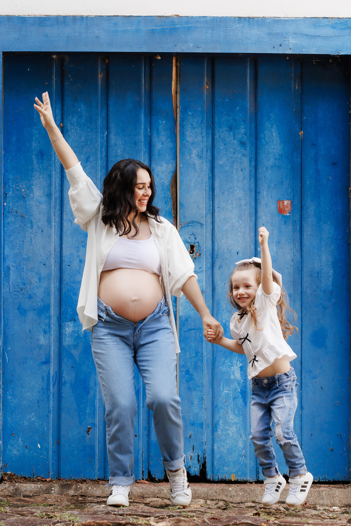 Momento divertido da gestante com sua filha durante ensaio gestante no parque.