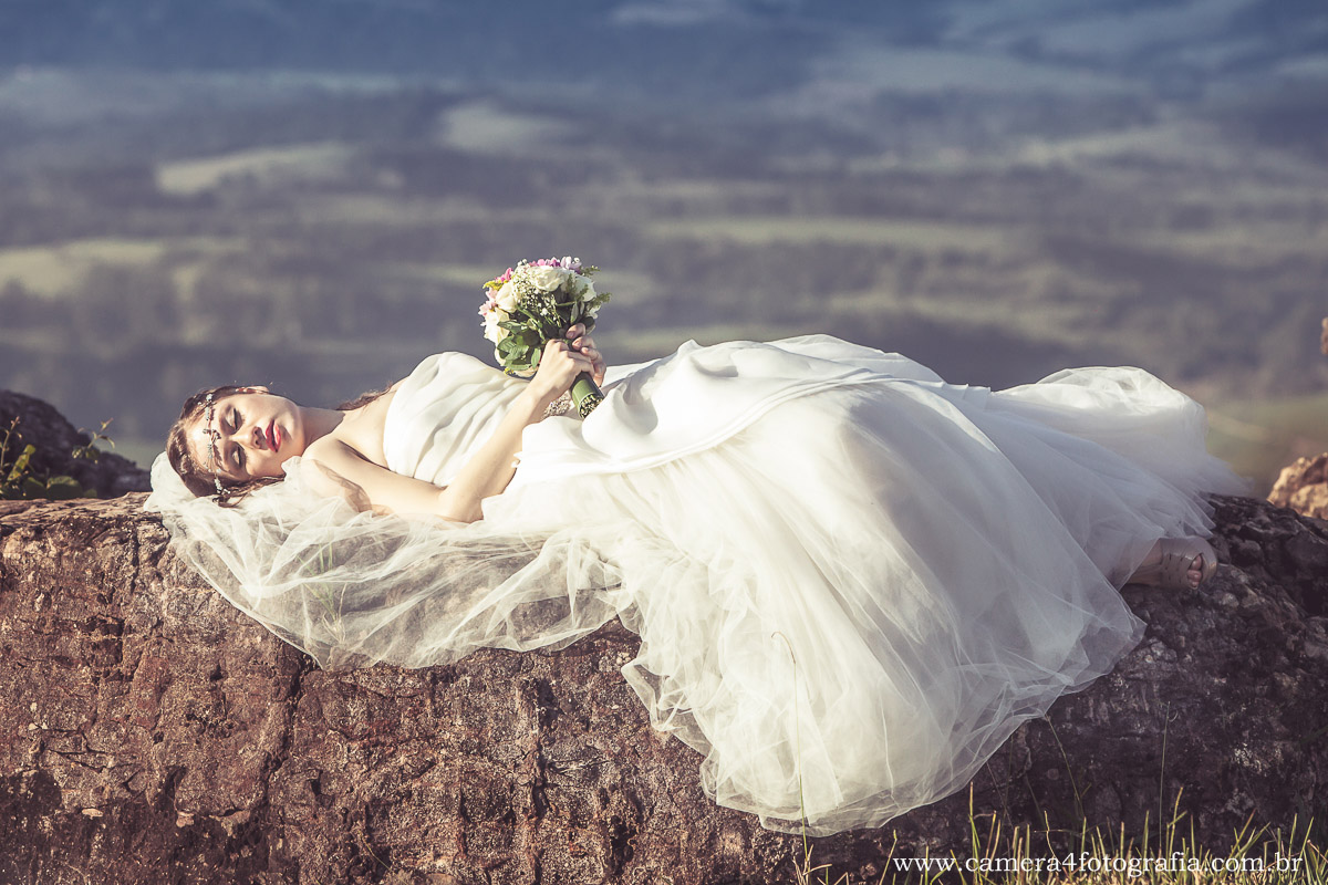 noiva deitada na pedra no ensaio pré wedding