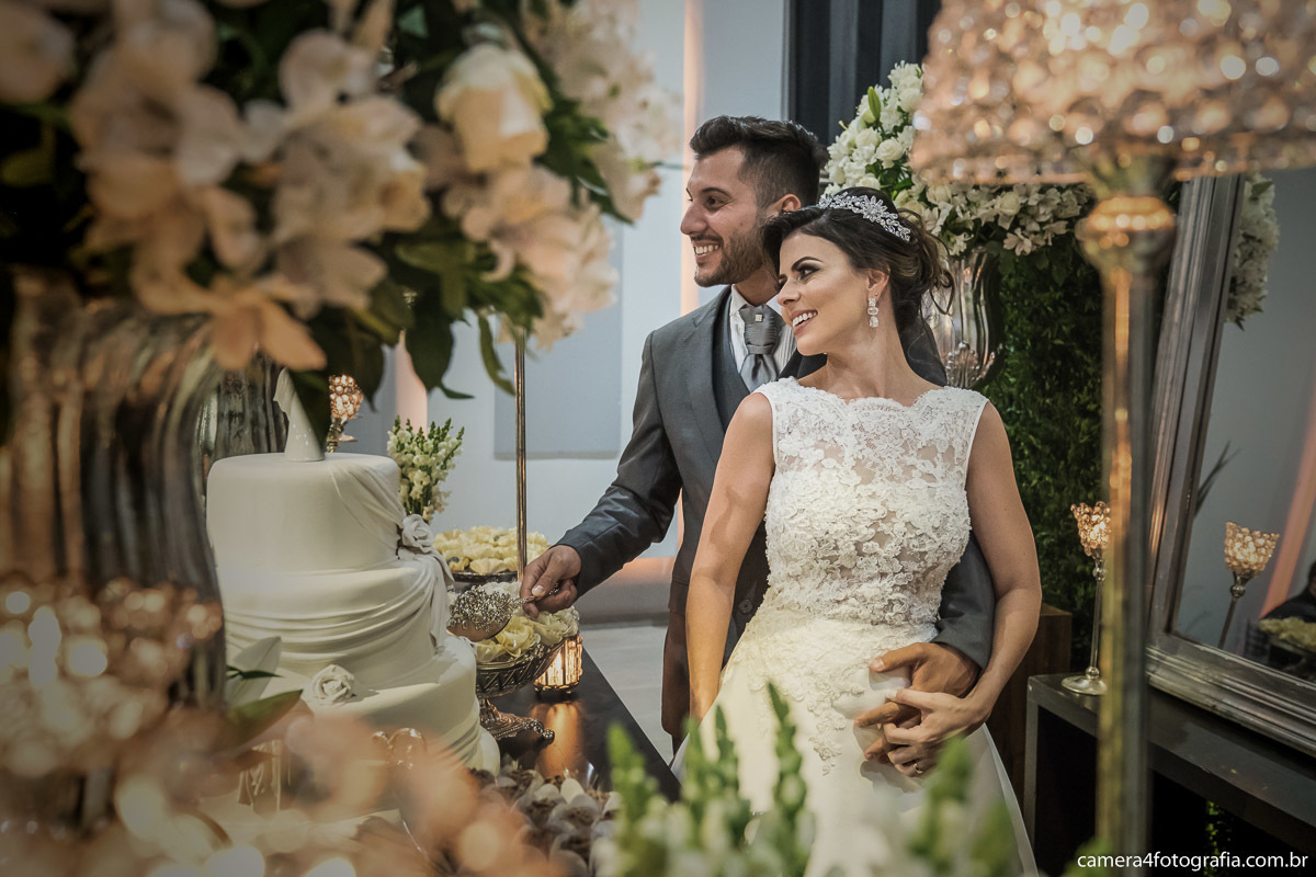 corte do bolo pelos noivos durante o casamento