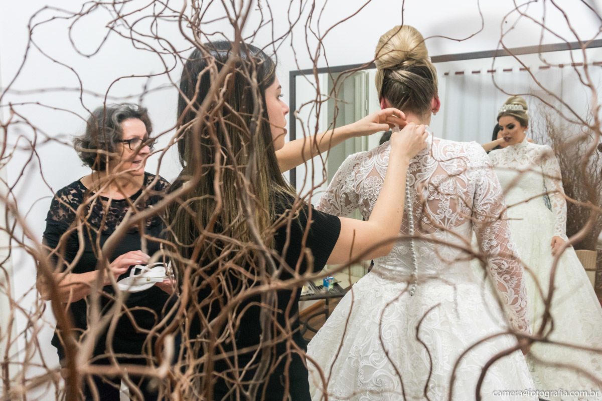 fechando o vestido da noiva antes do casamento