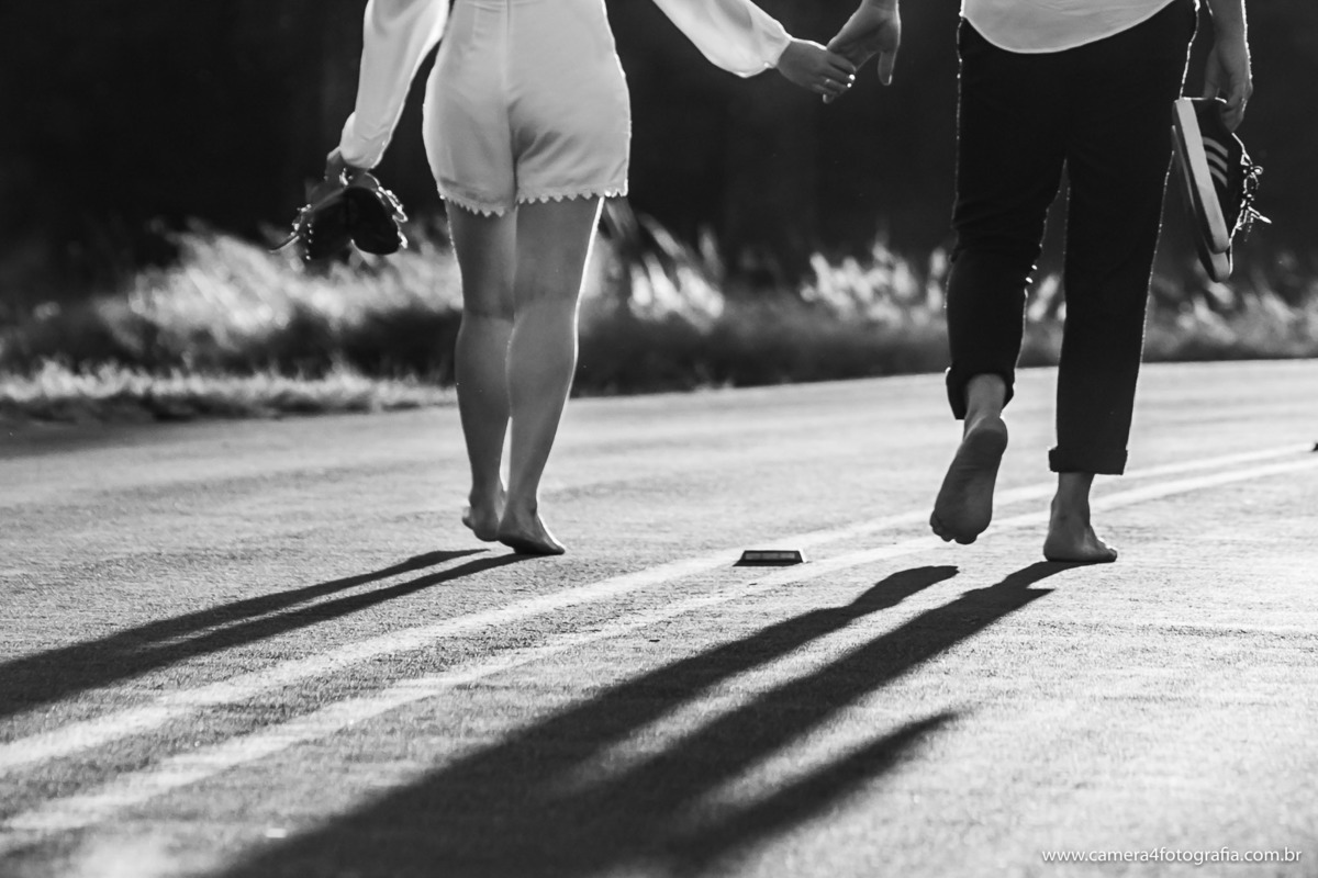 noivos caminhando na estrada durante o ensaio pré casamento em pardinho