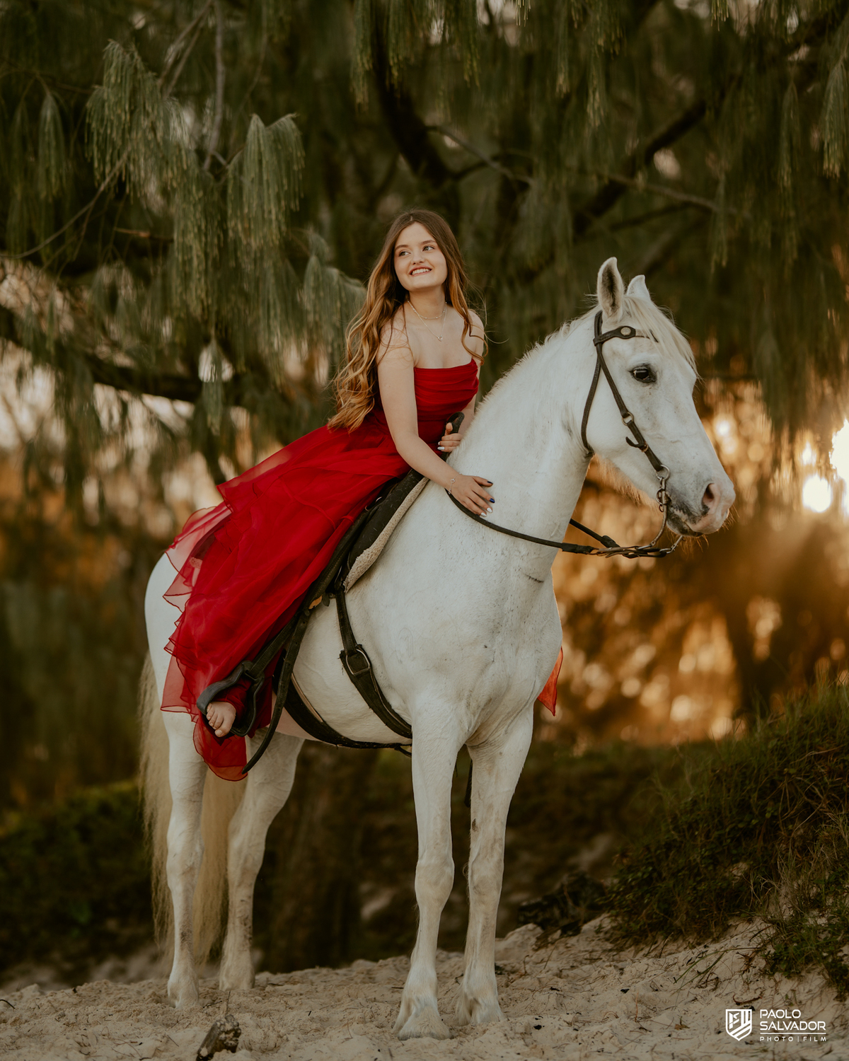 Ensaio de 15 anos na praia com cavalo em Florianópolis SC, close da debutante sorrindo no cavalo, fotógrafo de debutante Santa Catarina, ensaio feminino com cavalo ao pôr do so