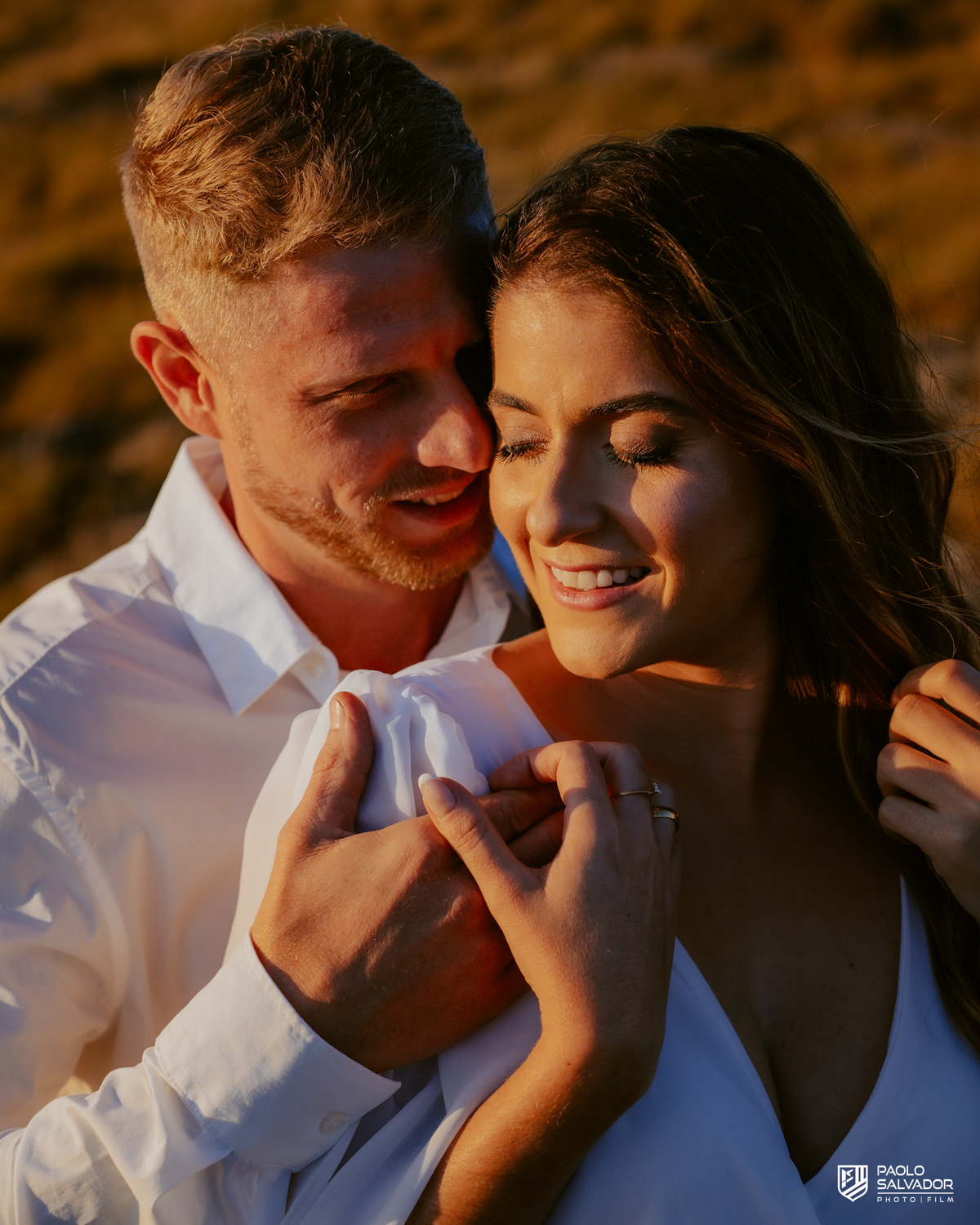 Close do casal em ensaio pré-wedding ao pôr do sol em Rancho Queimado, com luz dourada, conexão emocional e cenário de montanha na Serra Catarinense.