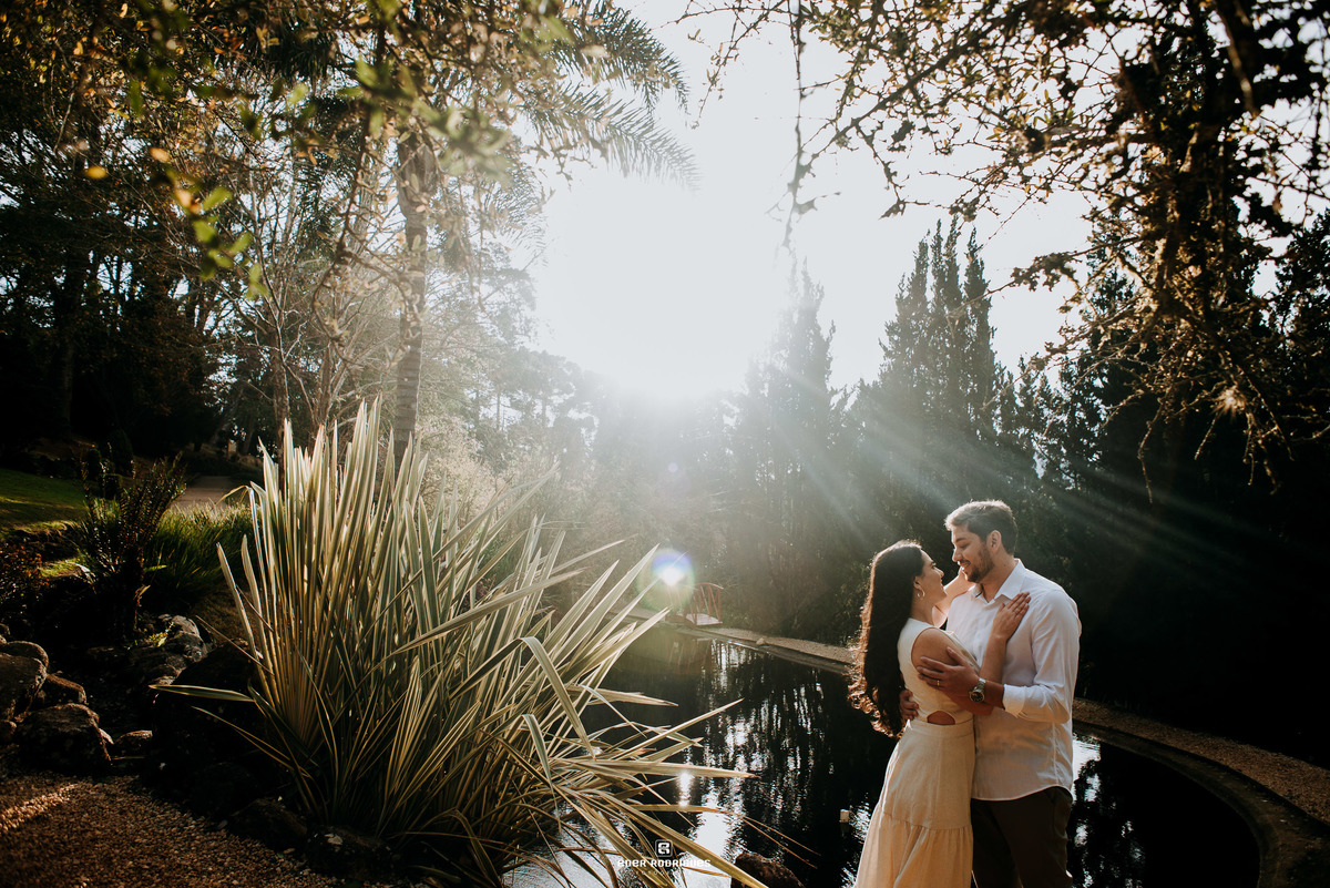 casal diante do brilho do sol no Jardim dos Pinhais Ecco Parque