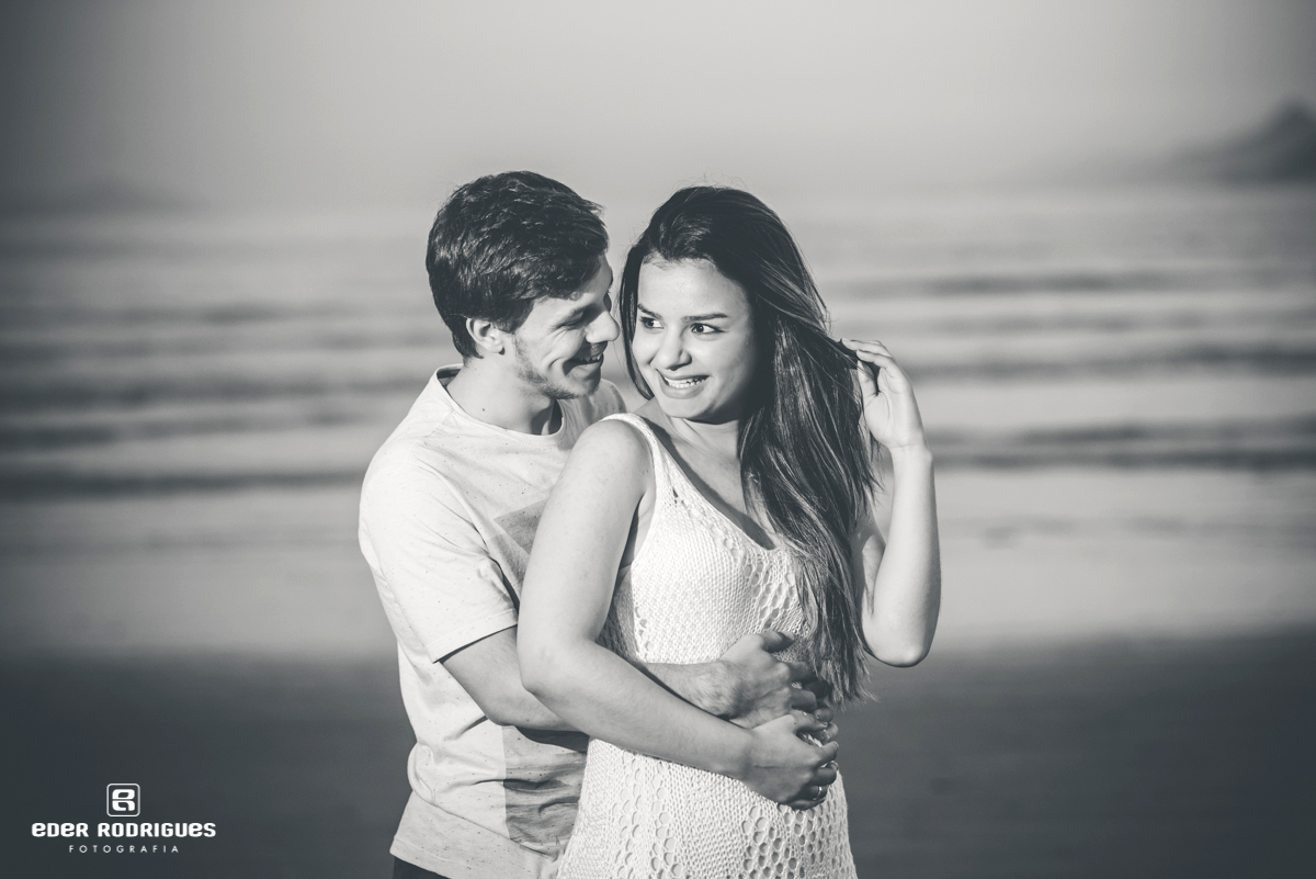 Noiva e noivo sorrindo na prainha