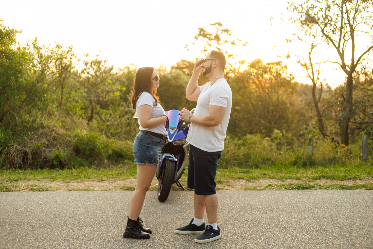 Ensaio pré-wedding realizado ao ar livre na serra do Japi em uma tarde ensolarada em Jundiaí com direito a fotos no pôr do sol. Imagem de um ensaio com um casal de motociclista e uma moto esportiva de alta velocidade. Fotografo de casamento.
