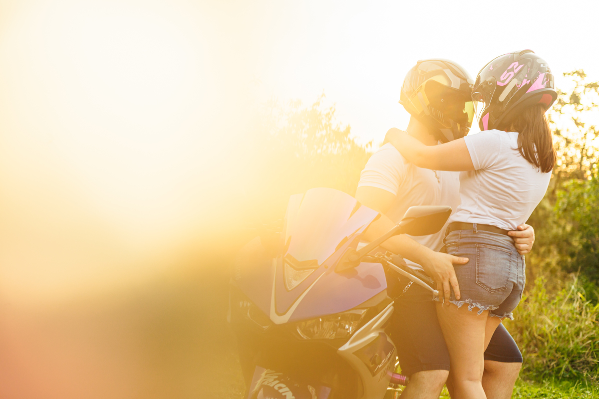 Ensaio pré-wedding realizado ao ar livre na serra do Japi em uma tarde ensolarada em Jundiaí com direito a fotos no pôr do sol. Imagem de um ensaio com um casal de motociclista e uma moto esportiva de alta velocidade. Fotografo de casamento.