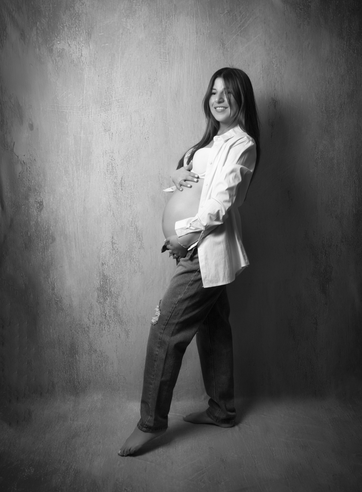 embarazada con look informal en jean y camisa en blanco y negro