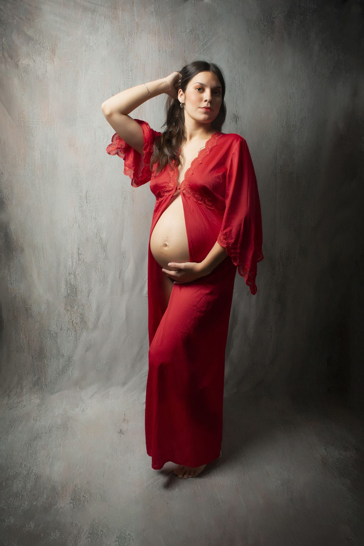 embarazada mostrando la panza con una bata roja
